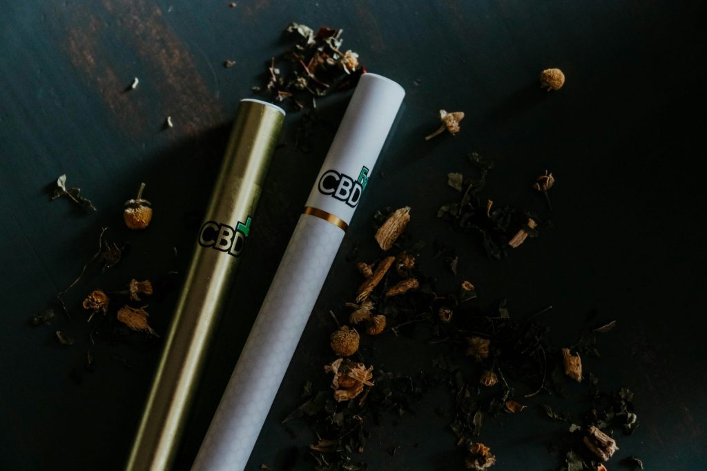 disposable cbd vape on black surface